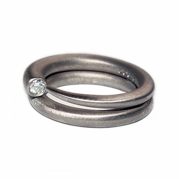 Simple elegant 18ct white gold ring with comfortable rounded band set with a brilliant 0.03ct diamond vsfg quality. The ring tapers from 3mm. (also available in 9ct & 18ct yellow gold, 9ct white gold and platinum - prices on request). This beautiful handcrafted ring is a perfect engagement ring.(in addition there is a 4mm version with 0.1ct diamond C18GW)