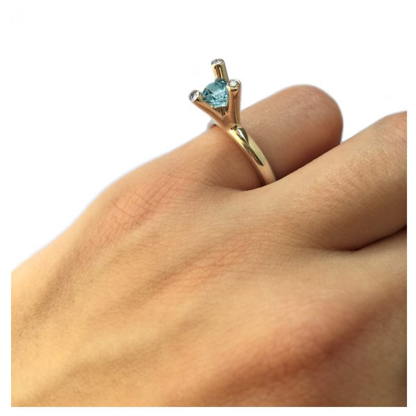 The 3 branch bough ring is bold and majestic in design and is inspired by nature. The silver ring has a comfortable rounded shank of 3mm and the setting consists of a 5mm gemstone encircled by 3x 0.02ct diamonds (height of setting when worn is approx 8mm). The featured image shows a 5mm blue topaz. The ring comes with a variety of gemstones for example amethyst, iolite, citrine, peridot & garnet.