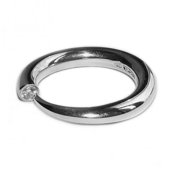 Hand forged silver tapering contemporary ring with a comfortable rounded band. The solid sterling silver band tapers to a point from 4mm and is end set with a brilliant  0.1ct vsfg diamond. The ring is one of the original designs in Paul’s timeless classic ”wiggly ” collection. This minimalist ring is practical and suitable for everyday wear or special occasions. It also makes the perfect engagement ring and can be paired with 4mm halo wedding ring C19. Platinum, 9ct/18ct white gold, 9ct/18ct yellow gold versions are available on request – please contact for further details. The ring is handmade to order to your specific finger size. Please let us know your ring size when you place your order. We have used the UK/AU sizing system, however, If you have a ring size based on EU, US/Canada or any other international sizing system we can convert it. The ring has a Paul Finch hallmark and conforms to the British hallmarking standard. It is delivered in a Paul Finch Jewellery box. Cleaning instructions For satin finish use silver dip, rinse in warm soapy water, dry thoroughly. For polished finish use silver polishing cloth/ and or silver dip. FREE Delivery The parcel will be sent out using secure Colissimo International tracked and signed for service and will require a signature on receipt. (UK customers: We will advise you when the parcel has arrived in the UK and is with Parcelforce. If there are any additional charges, they will be fully reimbursed). Despatched within 2-5 working days