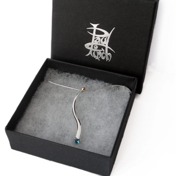 An elegant long curving wiggly pendant with 4mm faceted blue topaz and 18ct gold bead on a silver snake chain. The solid silver wiggly pendant tapers from 5mm and is approx 50mm long. The sweeping curves enhance the beautiful pure design.