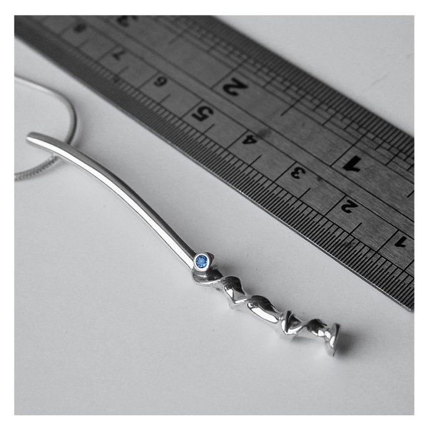 The long twist vine pendant is elegant and unusual. The delicate silver detail is enhanced with a sparkling 2mm blue topaz and contrasting polished finish.  The pendant is approximately 62mm long and has a width of 3mm. The pendant is available with a variety of gemstones and comes on a silver snake chain.