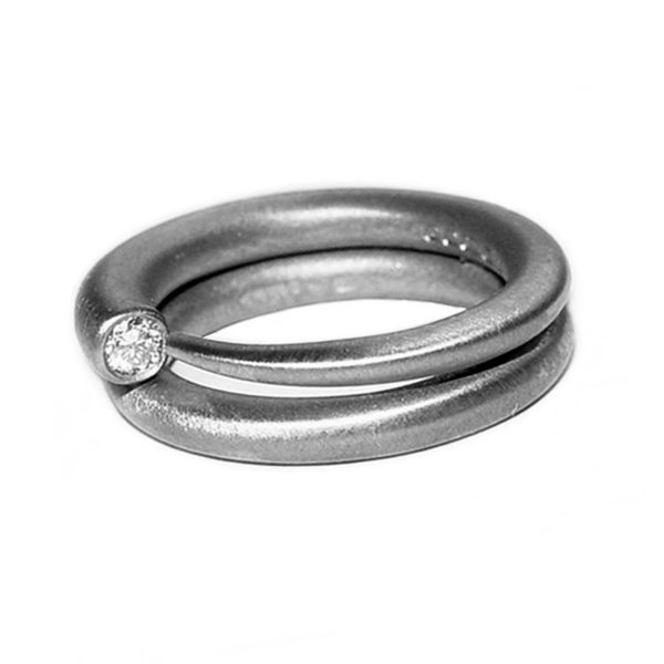 Simple elegant silver ring with comfortable rounded band set with a brilliant 3pt  (0.03ct) vsfg diamond. Dimensions: solid 3mm band tapering to a point. The ring is unusual and elegant and therefore makes the perfect engagement ring. In addition there is a matching wedding ring code c19A. 