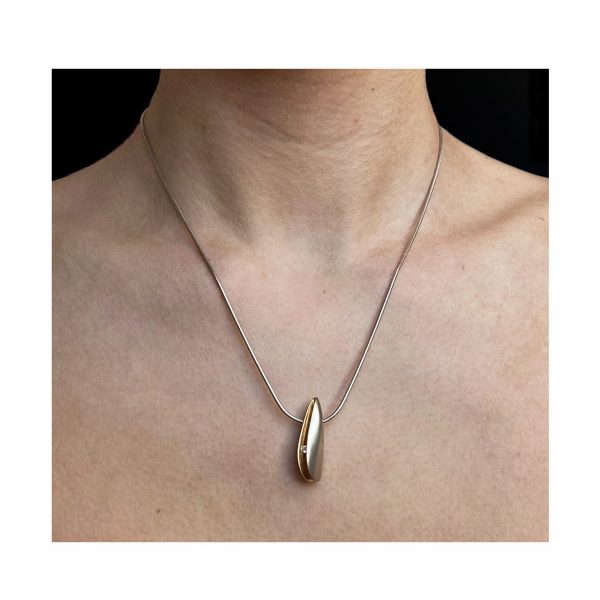 Solid side diamond silver shell pendant with 3pt (0.03ct vsfg) diamond in rich 22ct gold plated interior. It is 24mm in length, 4mm in width and 6mm in depth. The pendant usually comes in a satin finish on a silver snake chain.