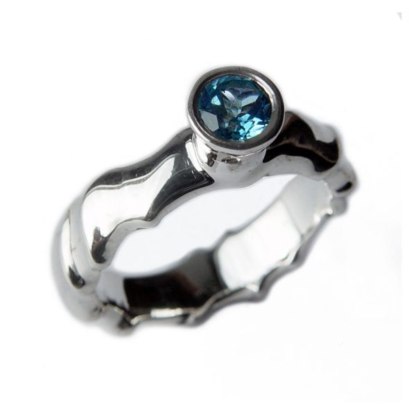 The silver gemset vine ring is striking and elegant. The centre piece of the ring is a sparkling 5mm blue topaz which compliments the delicate silver detailing of the band. The undulating band has a width of approximately 6mm at the widest point and a depth of approximately 2.5mm. The main picture shows the ring with blue topaz in a polished finish. If you would like an alternative gemstone our main choice includes blue topaz,amethyst, garnet, citrine, peridot, iolite. The ring is also available in a satin finish. The silver gemset vine ring is handmade to order to your specific finger size. Please let us know your ring size when you place your order. We have used the UK/AU sizing system, however. If you have a ring size based on EU, US/Canada or any other international sizing system we can convert it. The ring has a Paul Finch hallmark and conforms to the British hallmarking standard. It is delivered in a Paul Finch jewellery box. Cleaning instructions For satin finish use silver dip, rinse in warm soapy water, dry thoroughly. For polished finish use silver polishing cloth/ and or silver dip. FREE Delivery The parcel will be sent out using secure Colissimo International tracked and signed for service and will require a signature on receipt. Usually despatched within 2-5 working days