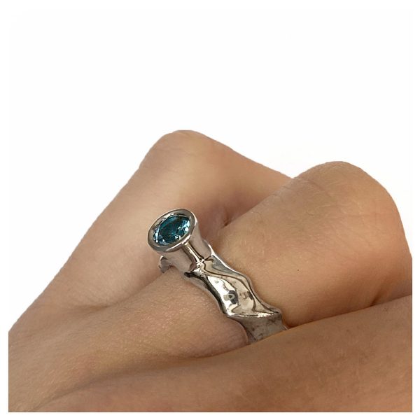 The silver gemset vine ring is striking and elegant. The centre piece of the ring is a sparkling 5mm blue topaz which compliments the delicate silver detailing of the band. The undulating band has a width of approximately 6mm at the widest point and a depth of approximately 2.5mm. The main picture shows the ring with blue topaz in a polished finish. If you would like an alternative gemstone our main choice includes blue topaz,amethyst, garnet, citrine, peridot, iolite. The ring is also available in a satin finish. The silver gemset vine ring is handmade to order to your specific finger size. Please let us know your ring size when you place your order. We have used the UK/AU sizing system, however. If you have a ring size based on EU, US/Canada or any other international sizing system we can convert it. The ring has a Paul Finch hallmark and conforms to the British hallmarking standard. It is delivered in a Paul Finch jewellery box. Cleaning instructions For satin finish use silver dip, rinse in warm soapy water, dry thoroughly. For polished finish use silver polishing cloth/ and or silver dip. FREE Delivery The parcel will be sent out using secure Colissimo International tracked and signed for service and will require a signature on receipt. Usually despatched within 2-5 working days