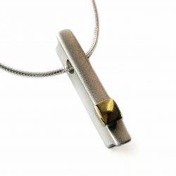 Silver 18ct ingot necklace.The solid silver pendant has contrasting chunky 18ct yellow gold detail. Approximate dimensions are length 24mm, width 4mm, depth 5mm. The pendant comes on a silver snake chain.  