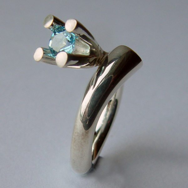 The tapering bough ring is inspired by nature. The ring has a solid silver band which tapers from 5mm and It is 3.5mm across the back. It is crowned with a majestic 4 branch gemset design (image featured shows 5mm blue topaz). 