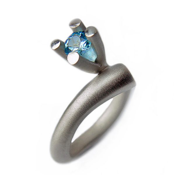 The tapering bough ring is inspired by nature. The ring has a solid silver band which tapers from 5mm and It is 3.5mm across the back. It is crowned with a majestic 4 branch gemset design (image featured shows 5mm blue topaz). 