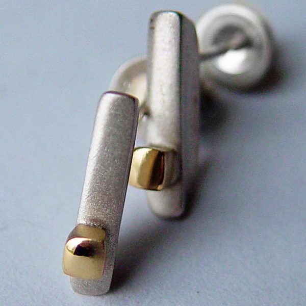 Silver 18ct ingot earrings. These unusual silver drop stud earrings have contrasting 18ct gold detail.  The earrings have approximate maximum dimensions of 15mm with a width of 3mm and depth of 4mm.  They have a simple ear post and bell scroll fixing and are featured in a satin finish with polished 18ct yellow gold detail. You can clean the earrings with silver dip, rinse in warm soapy water, dry thoroughly. For polished finish use silver polishing cloth/ and or silver dip. The silver 18ct ingot earrings are delivered in a Paul Finch Jewellery gift box. FREE Delivery The parcel will be sent out using secure Colissimo International tracked and signed for service and will require a signature on receipt. The earrings will be despatched within 1-3 working days.