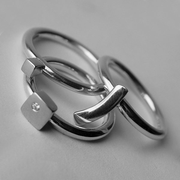 This silver diamond ring set consists of three individual rings. Each sterling silver ring is 2.5mm round with a comfortable rounded shank (maximum width of ring set is 7.5mm). Each silver ring has contrasting silver detail and one ring is set with a single diamond (0.02ct vsfg). The ring set is also available with 18ct yellow gold detail, or in a solid 18ct yellow gold version. The rings can be worn in any combination within the set, and can also be bought individually on request. Ring set 1 is handmade to order and comes in a wide range of sizes including 1/2 sizes.  Please let us know your ring size when you place your order. We use the UK/AU sizing system, however. If you have a ring size based on EU, US/Canada or any other international sizing system we can convert it. The silver diamond ringset is hallmarked & comes in a branded jewellery box.