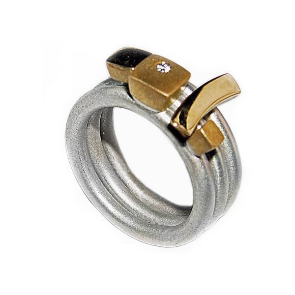 This silver 18ct diamond ringset 3G consists of three individual rings. Each sterling silver ring is 2.5mm round with a comfortable rounded shank (maximum width of ring set is 7.5mm). Each silver ring has contrasting 18ct yellow gold detail and one ring is set with a single diamond (0.02ct vsfg). The ring set is also available with silver detail, or in a solid 18ct yellow gold version. The rings can be worn in any combination within the set, and can also be bought individually on request.
