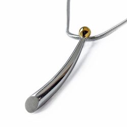 Small silver wiggly pendant with 18ct gold detail. The pendant tapers from 4mm and is approx 25mm long. It comes on a silver snake chain.