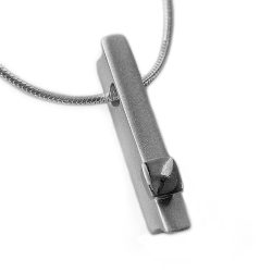 This silver ingot necklace has contrasting polished silver detail & approximate dimensions of length 24mm, width 4mm, depth 5mm. The pendant comes on a silver snake chain with a thickness of 1.25mm. Please let us know if you would like a 16”/40cm, 18”/45cm, or 20”/50cm chain when you place your order. The solid silver necklace is perfect for everyday wear or special occasions.  The silver ingot necklace has a Paul Finch hallmark and conforms to the British hallmarking standard. It is delivered in a Paul Finch jewellery box.