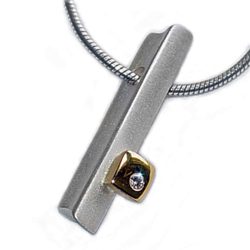 Silver 18ct diamond ingot The solid silver pendant has contrasting chunky 18ct yellow gold detail set with solitary sparkling diamond