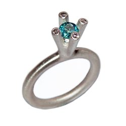 The 4 branch bough ring is bold and majestic in design and is inspired by nature. The silver ring has a comfortable rounded band of 3mm and the setting consists of a 5mm gemstone encircled by 4x 0.02ct diamonds (height of setting when worn is approx 8mm). The featured image shows a 5mm blue topaz. The ring comes with a variety of gemstones for example amethyst, iolite, citrine, peridot & garnet.