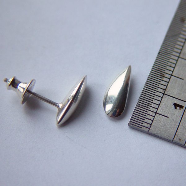 Small side shell studs with smooth organic form. The solid silver earrings are height 13mm width 6mm depth 3mm. 