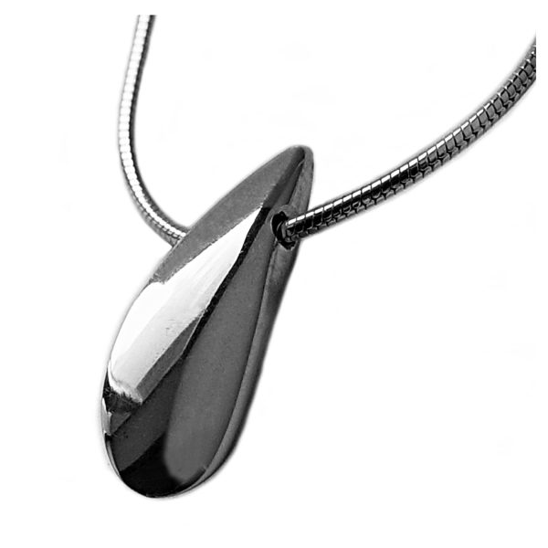 The plain side shell pendant has a smooth organic form. It is approx 22mm long with a width of 4mm and a depth of 8mm at the widest point. The pendant comes on a silver snake chain.