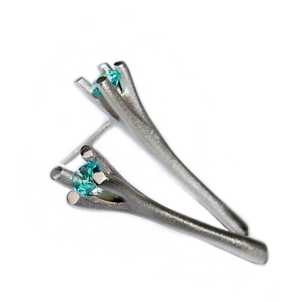The 4 branch silver drop studs with blue topaz are elegant and unusual solid silver earrings. The unusual setting consists of a faceted blue topaz gemstone enclosed in 4 silver branches. The earrings also come with other gemstones for example amethyst, iolite, citrine, peridot and garnet and cubic zirconia. Solid silver earrings in satin finished or polished sterling silver. Approximate maximum dimensions are 30mm in length with a width 2mm They have a simple ear post and bell scroll fitting