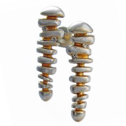 925 sterling silver earrings with diamond and 22k gold plating. The long silver diamond drop studs are simple and elegant. These unique solid silver earrings have contrasting 22ct gold plating and each is set with x2 0.015ct diamonds. The diamond earrings are 24mm long with a tapering width of approx 6.5mm to 3.5mm & a depth of approx 3.8mm. The long silver diamond drop studs are delivered in a Paul Finch jewellery gift box. Cleaning instructions For satin finish use silver dip, rinse in warm soapy water, dry thoroughly. For polished finish use silver polishing cloth/ and or silver dip.