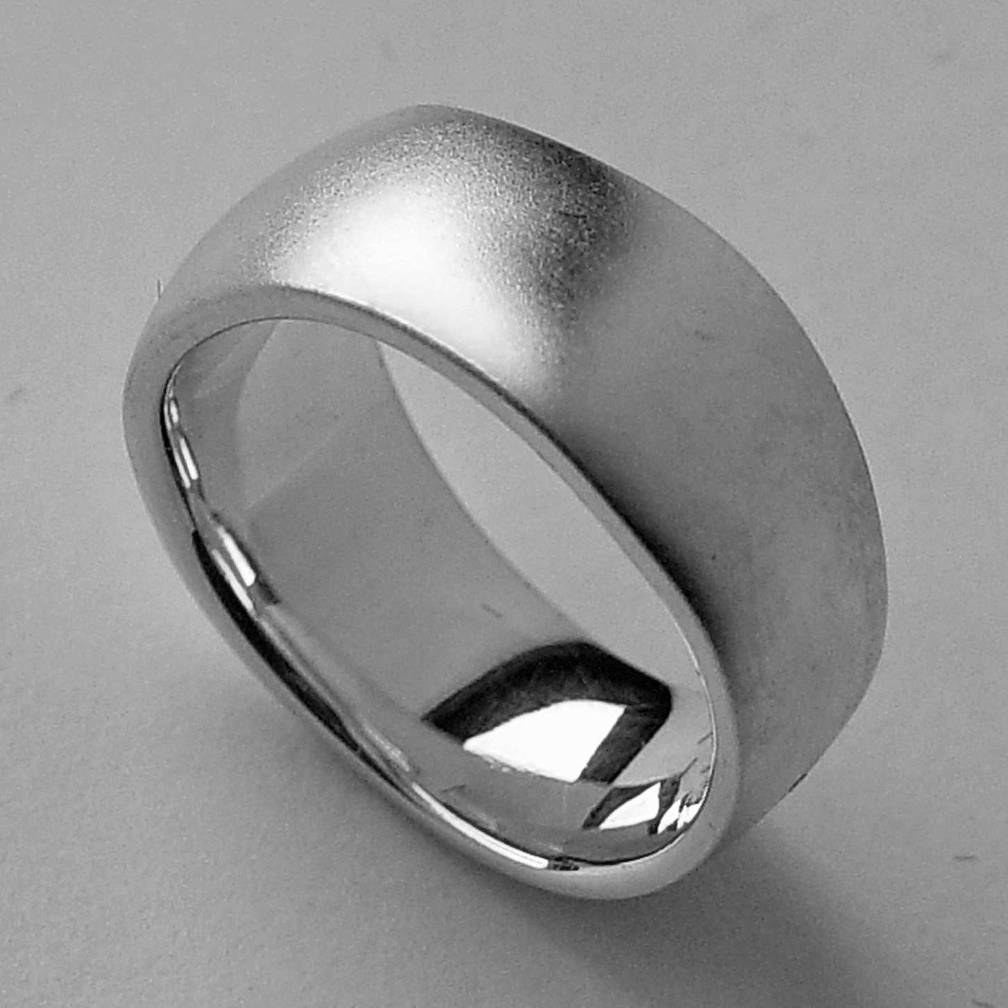 An unusual organic silver band. The smooth solid undulating band is approx 11mm at the widest point and has a varying depth of 2-3mm. It is practical and comfortable to wear. The ring is individually handmade to order and is available in a wide range of sizes including 1/2 sizes. Please let us know your ring size when you place your order. We use the UK/AU sizing system, however. If you have a ring size based on EU, US/Canada or any other international sizing system we can convert it. If you would like the ring in 18ct gold, please contact us for more details. The organic silver band has a Paul Finch hallmark and conforms to the British hallmarking standard. It comes in a branded jewellery box.