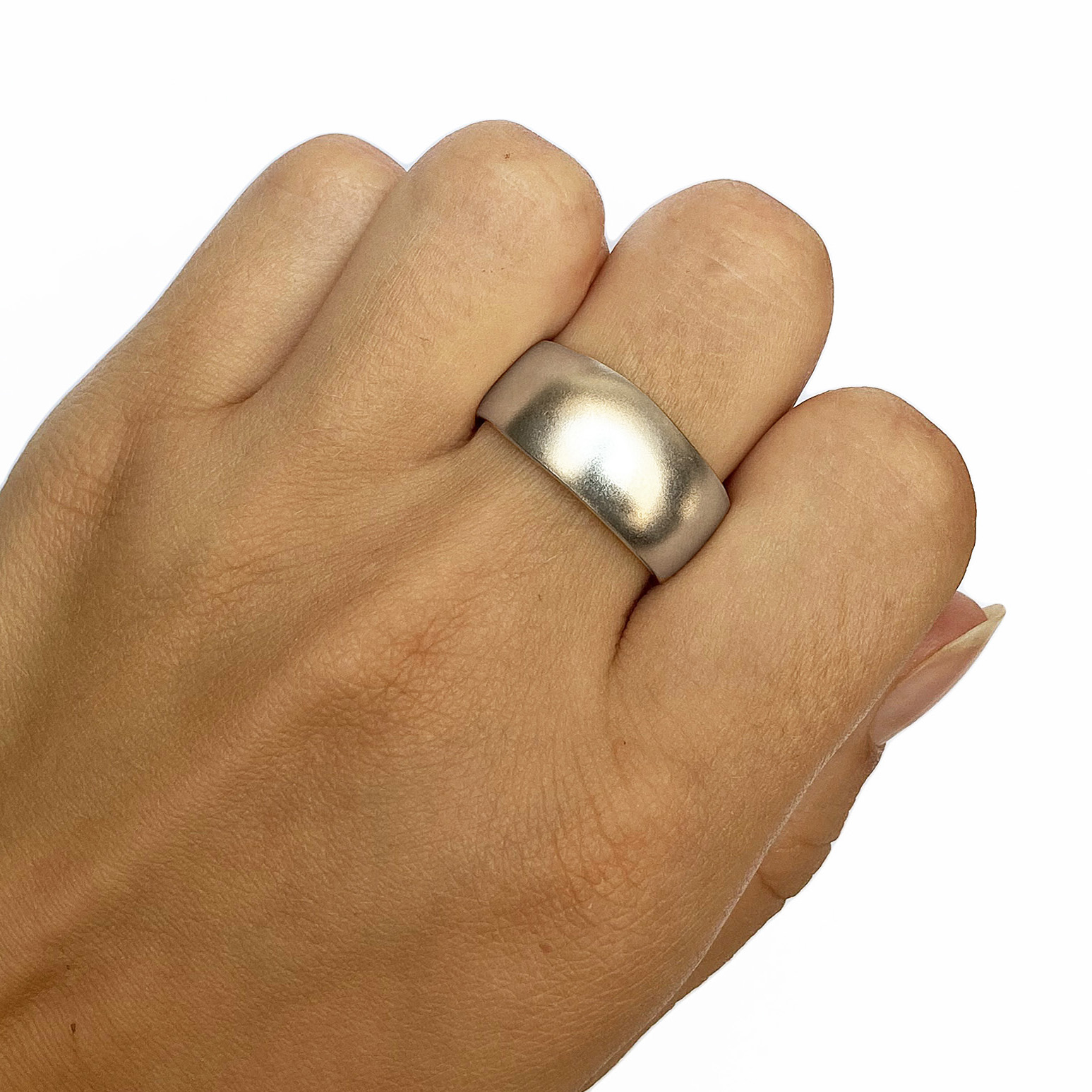 An unusual organic silver band. The smooth solid undulating band is approx 11mm at the widest point and has a varying depth of 2-3mm. It is practical and comfortable to wear. The ring is individually handmade to order and is available in a wide range of sizes including 1/2 sizes. Please let us know your ring size when you place your order. We use the UK/AU sizing system, however. If you have a ring size based on EU, US/Canada or any other international sizing system we can convert it. If you would like the ring in 18ct gold, please contact us for more details. The organic silver band has a Paul Finch hallmark and conforms to the British hallmarking standard. It comes in a branded jewellery box.