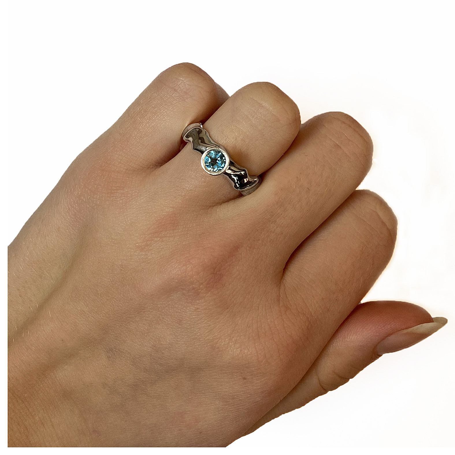 The silver gemset vine ring is striking and elegant. The centre piece of the ring is a sparkling 5mm blue topaz which compliments the delicate silver detailing of the band. The undulating band has a width of approximately 6mm at the widest point and a depth of approximately 2.5mm. The main picture shows the ring with blue topaz in a polished finish. If you would like an alternative gemstone our main choice includes blue topaz,amethyst, garnet, citrine, peridot, iolite. The ring is also available in a satin finish. The silver gemset vine ring is handmade to order to your specific finger size. Please let us know your ring size when you place your order. We have used the UK/AU sizing system, however. If you have a ring size based on EU, US/Canada or any other international sizing system we can convert it. The ring has a Paul Finch hallmark and conforms to the British hallmarking standard. It is delivered in a Paul Finch jewellery box. Cleaning instructions For satin finish use silver dip, rinse in warm soapy water, dry thoroughly. For polished finish use silver polishing cloth/ and or silver dip. FREE Delivery The parcel will be sent out using secure Colissimo International tracked and signed for service and will require a signature on receipt. Usually despatched within 2-5 working days